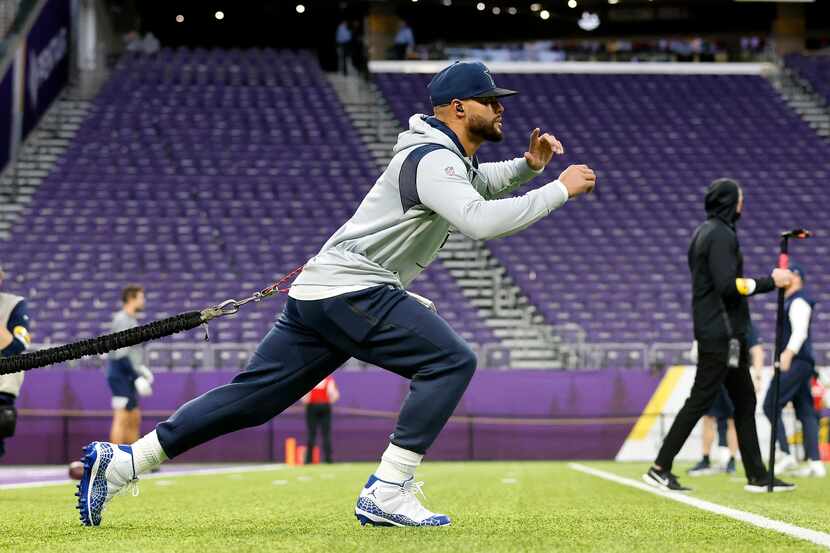Dallas Cowboys quarterback Dak Prescott stretches and warms up before their game against the...