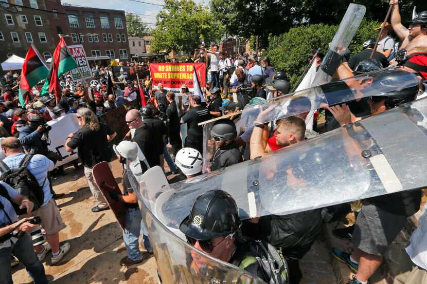 White nationalist demonstrators use shields as they clash with counter demonstrators at the...
