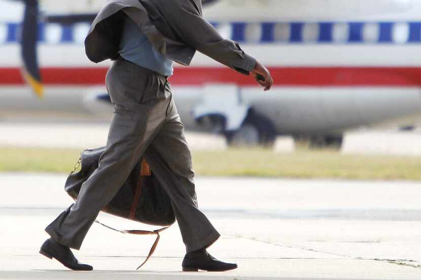 Texas Rangers' Vladimir Guerrero walks to an airplane at Dallas-Fort Worth International...