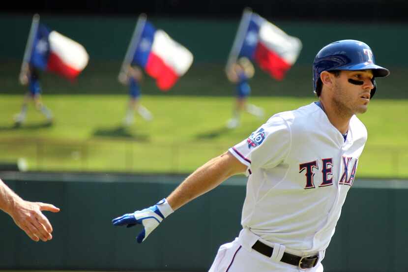Texas' Ian Kinsler circles the bases after hitting a home run to lead off the bottom of the...