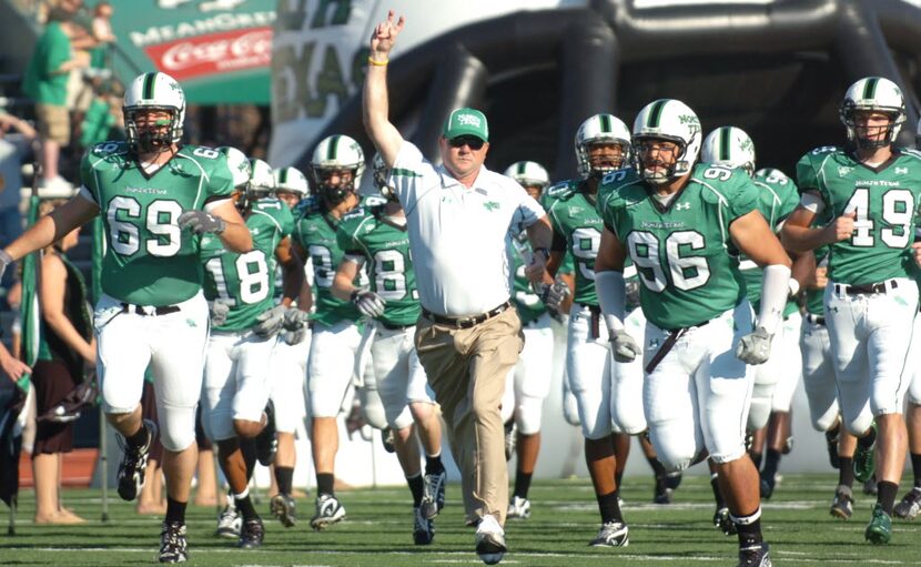 ORG XMIT: txder101 University of North Texas football head coach Todd Dodge throws up the...