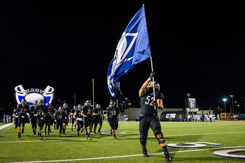 Wylie East offensive lineman Peter Ihaka (52) leads his teammates on to the field for the...