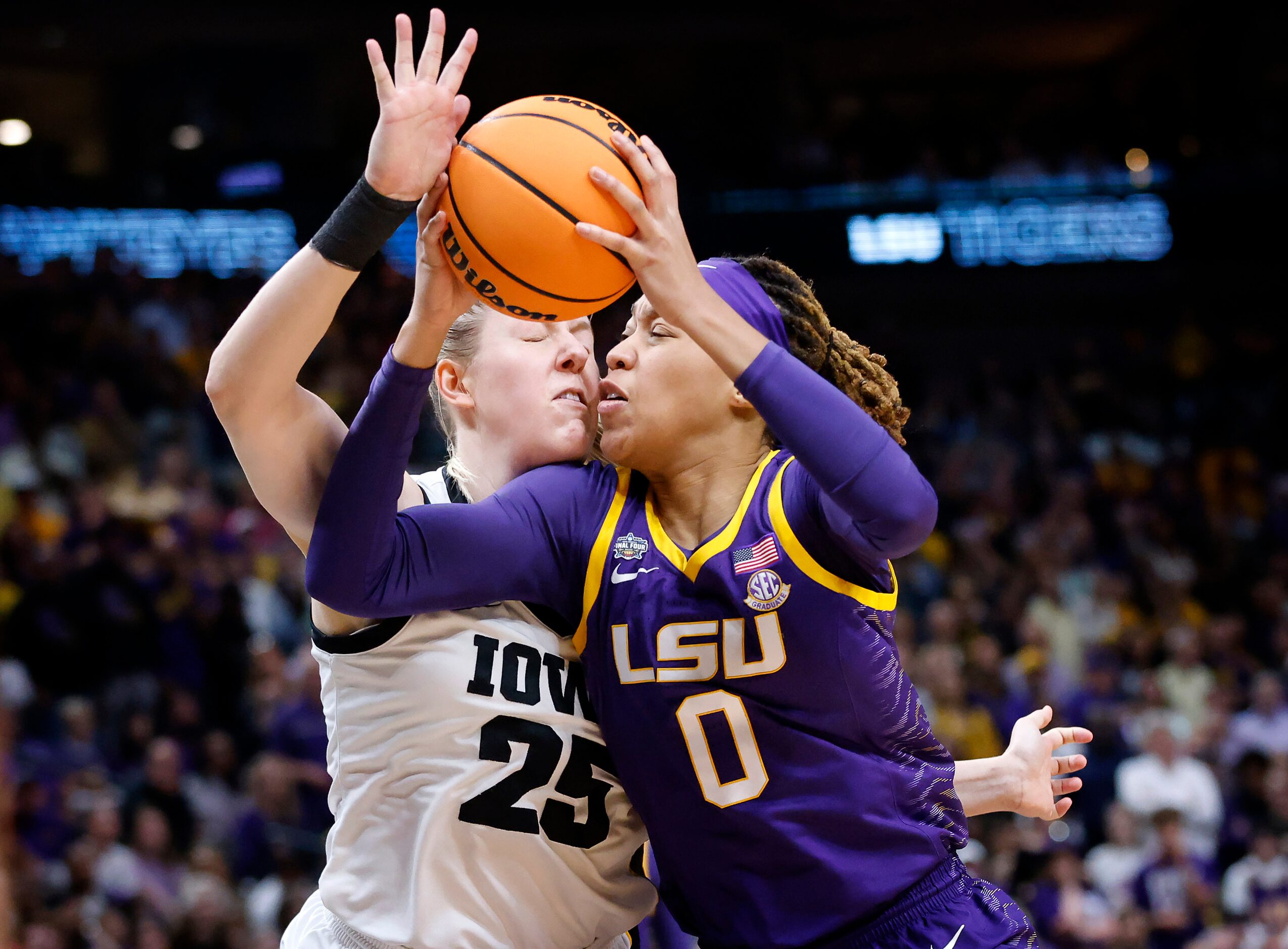 LSU Lady Tigers forward LaDazhia Williams (0) collides with Iowa Hawkeyes forward Monika...