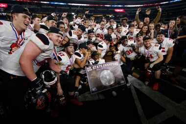 Members of the Aledo Bearcats pose for a photo with their medals and championship trophy...