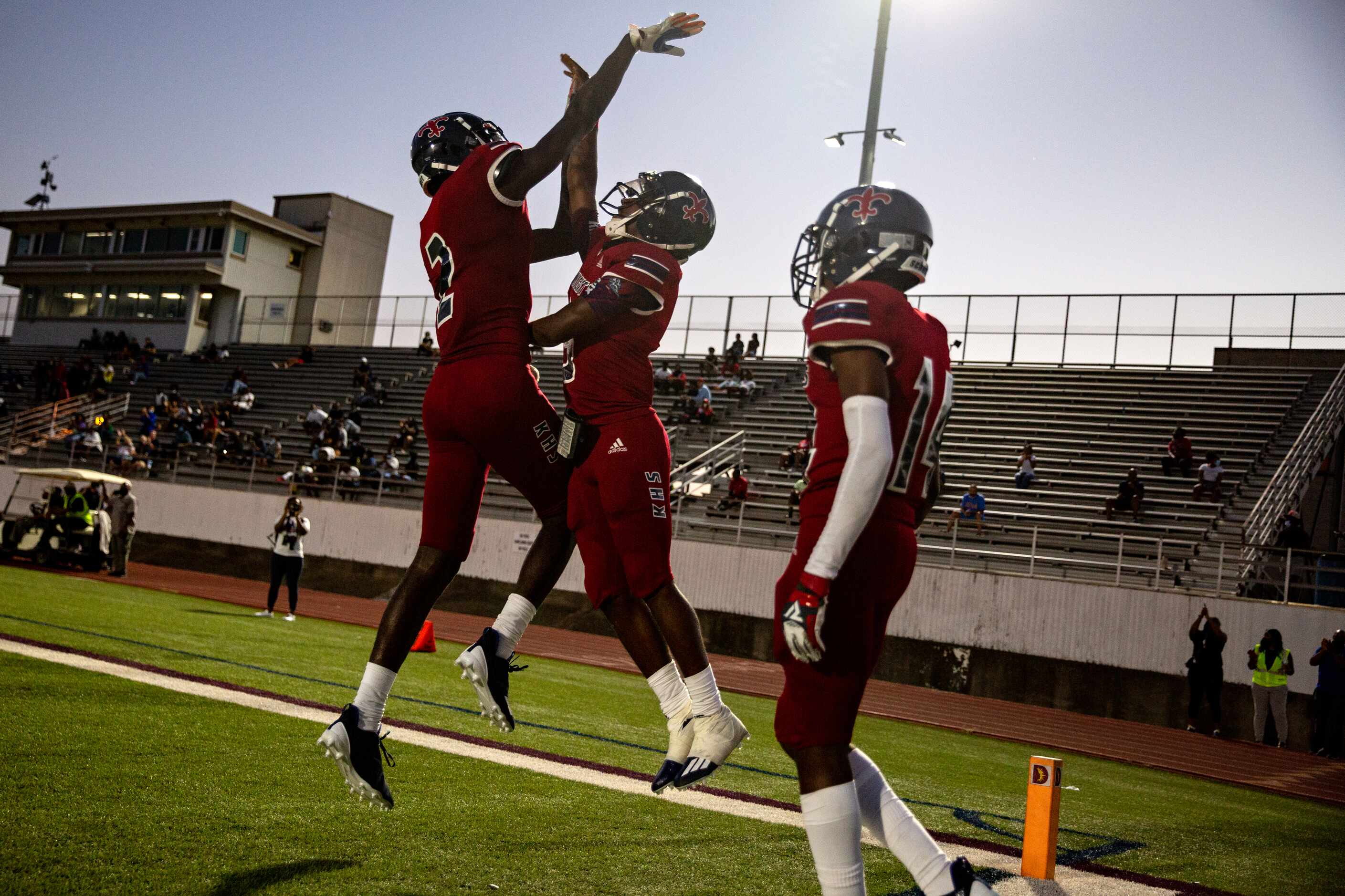 Justin F. Kimball High School players celebrate after a touchdown during their...