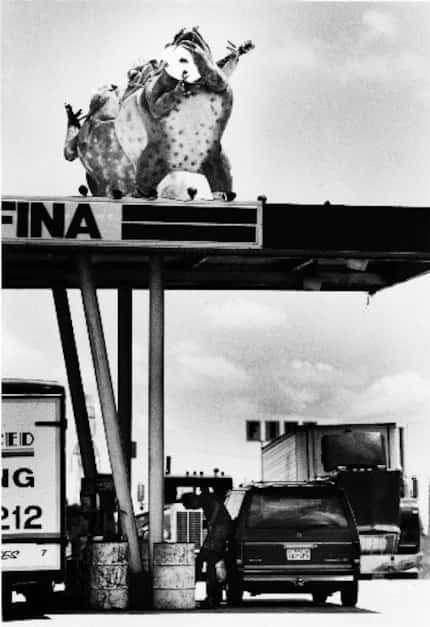 Three of the six Tango Frogs greet motorists as they gas up at Carl's Corner in 1984.  The...