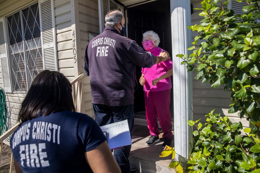 Elida Garza, 87, greeted firefighter/paramedics Steve Bowers and Kassandra Goce as they...