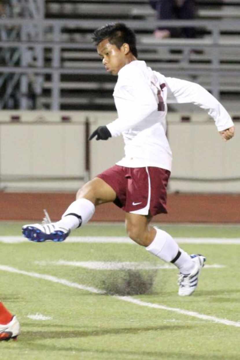 
Van Thang launches the ball downfield in a match against Marcus High School.
