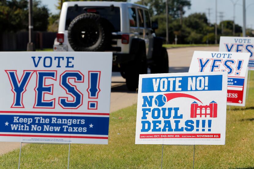 Campaign signs supporting and opposing public assistance for a new Texas Rangers stadium....