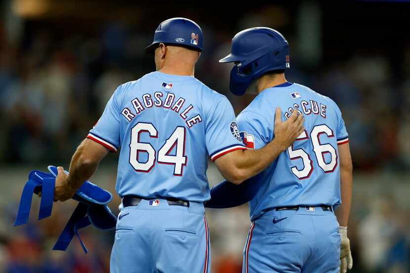 Texas Rangers first base coach Corey Ragsdale (64) talks with pinch hitter Justin Foscue...