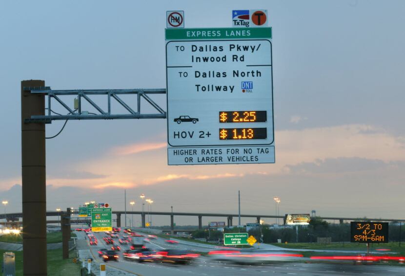 Tollway signs post the cost for travelers on the eastbound lane of LBJ. Under a plan...