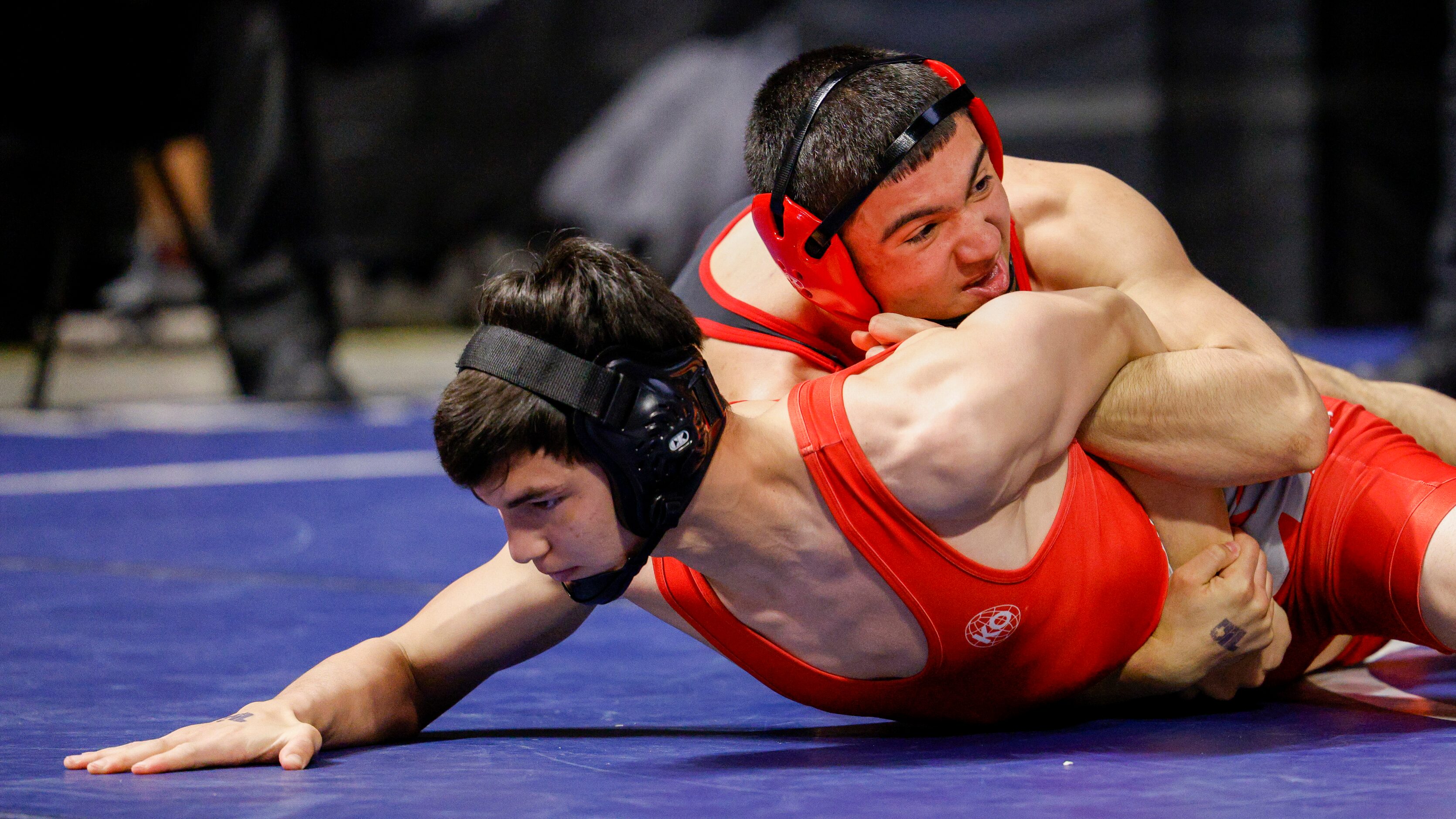 Kade Moore of Allen (left) wrestles Connor Timmons of Katy. during a quarterfinal match of...