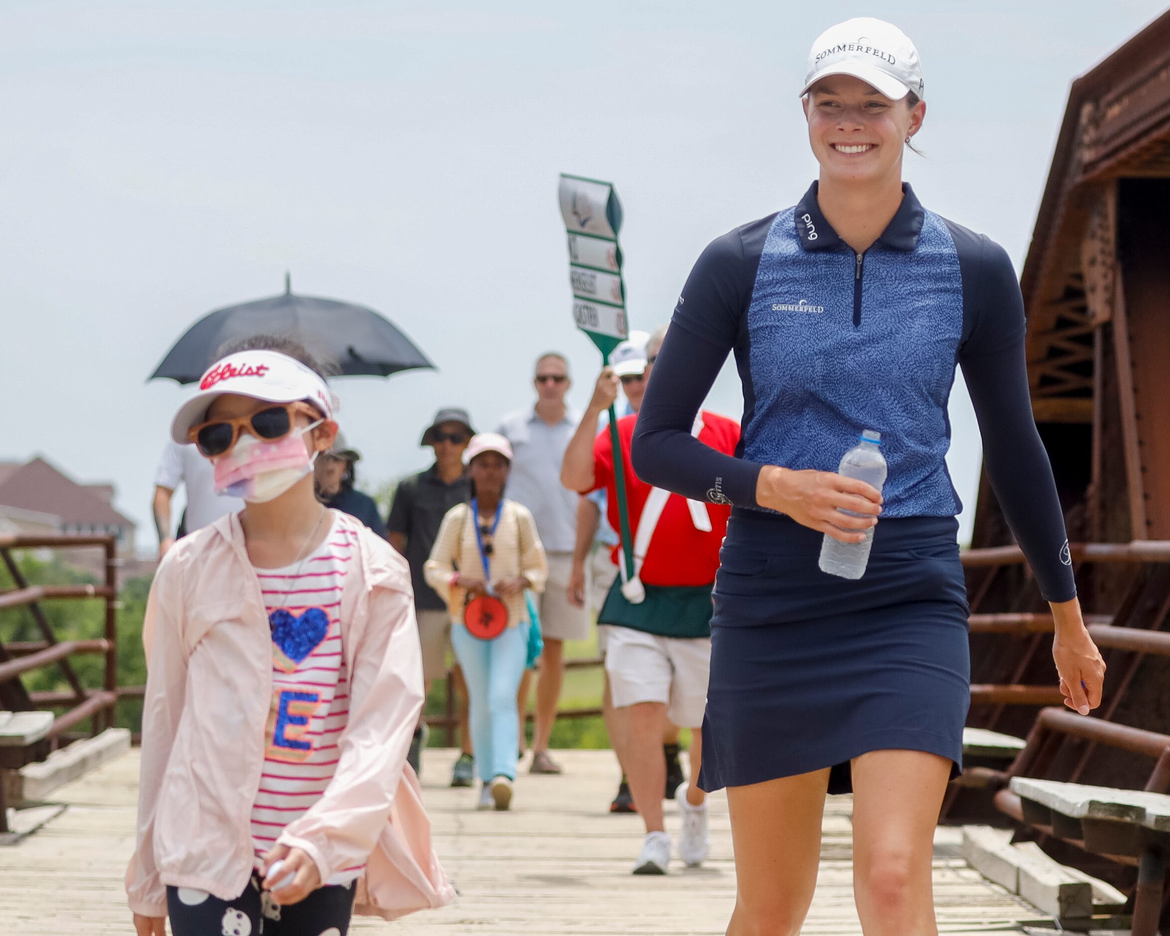 Professional golfer Esther Henseleit smiles as she crosses the Old American Bridge with a...