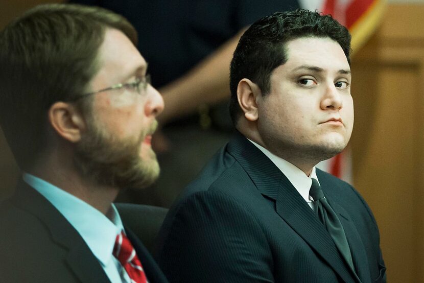 Defense attorney Keith Gore and client Enrique Arochi (right) waited in court last week for...