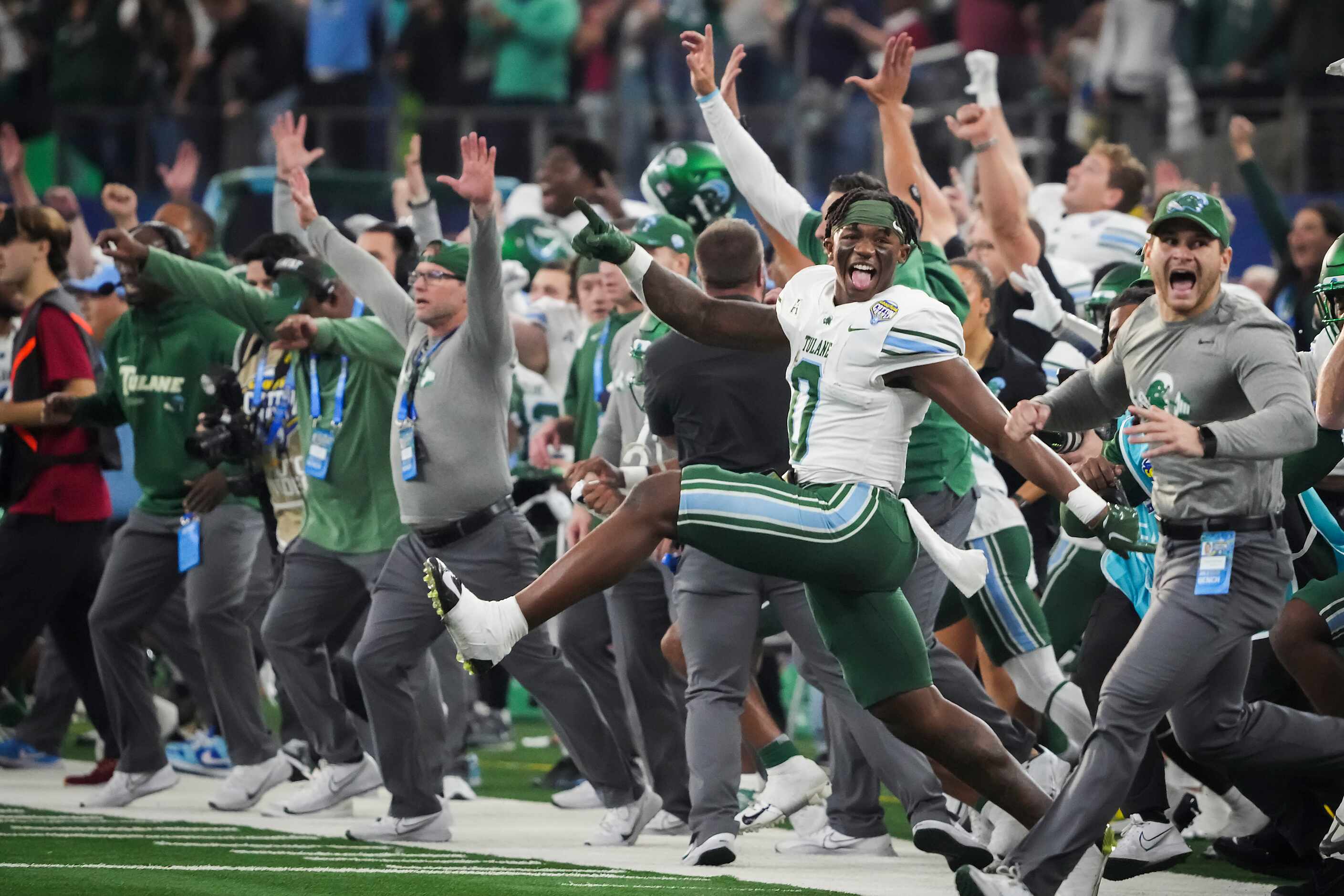 The Tulane bench, including running back Shaadie Clayton-Johnson (0) rush the field as time...