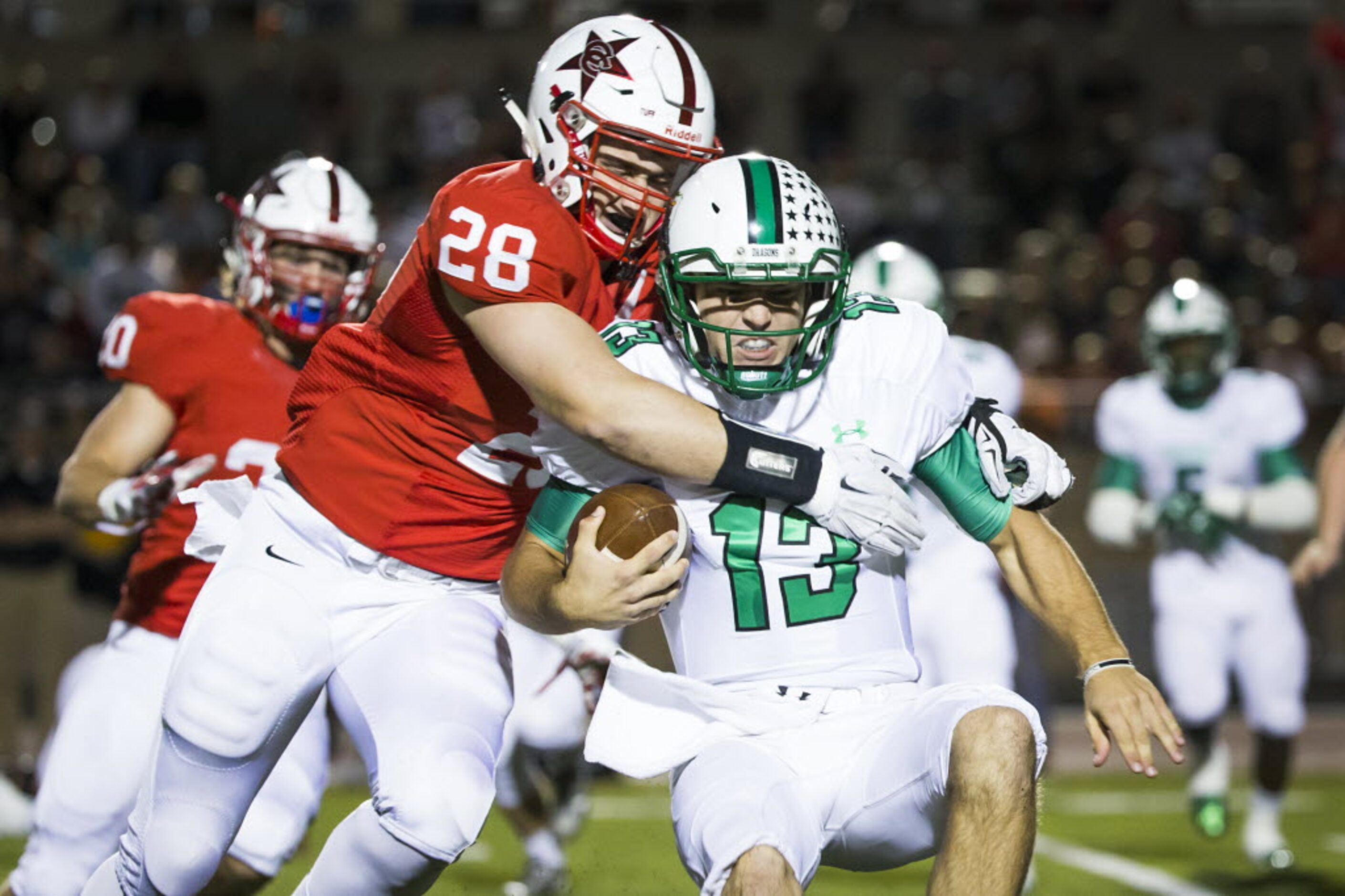 Southlake Carroll quarterback Mason Holmes (13) is sacked by Coppell linebacker Tyler Bell...