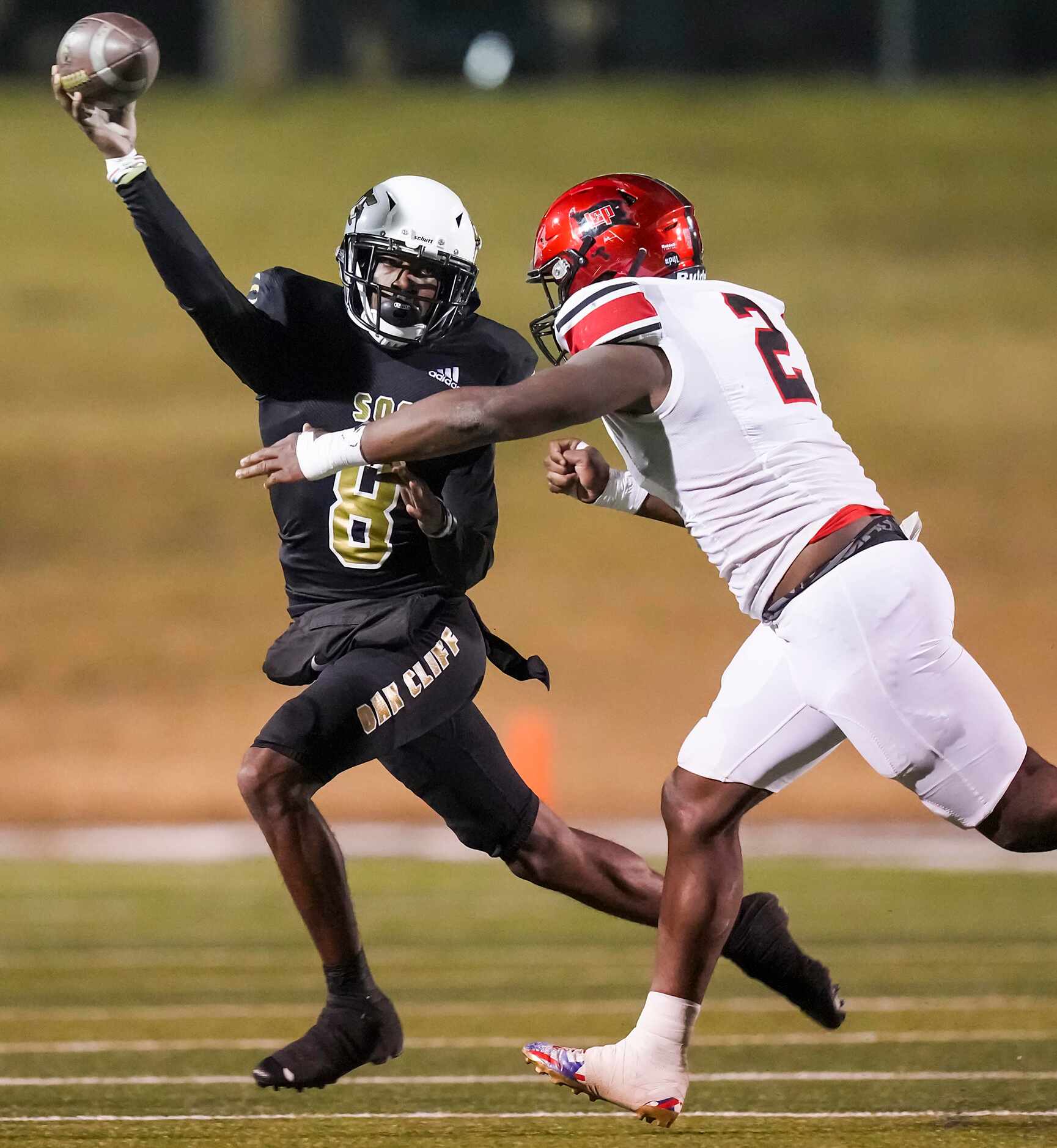 South Oak Cliff quarterback Kevin Henry-Jennings (8) throws a pass under pressure from...