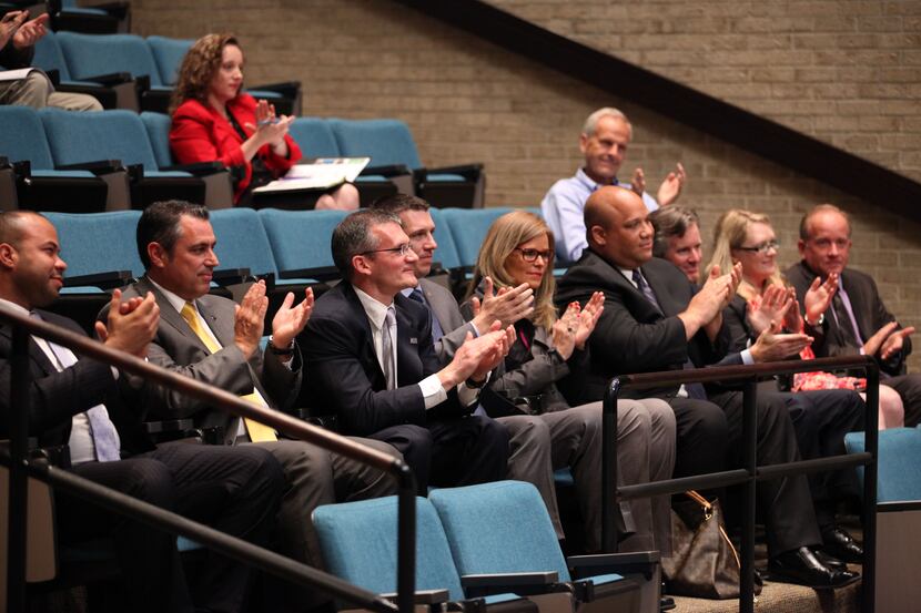Toyota representatives, in the front row, applauded after a vote for an economic incentive...