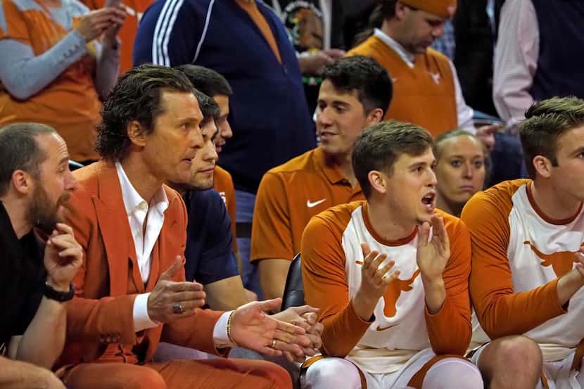 Texas fan Matthew McConaughey, second from left, cheers on the Texas Longhorn team from...