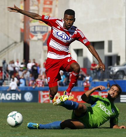 FC Dallas defender/midfielder Kellyn Acosta (23) hurdles Seattle Sounders FC defender...