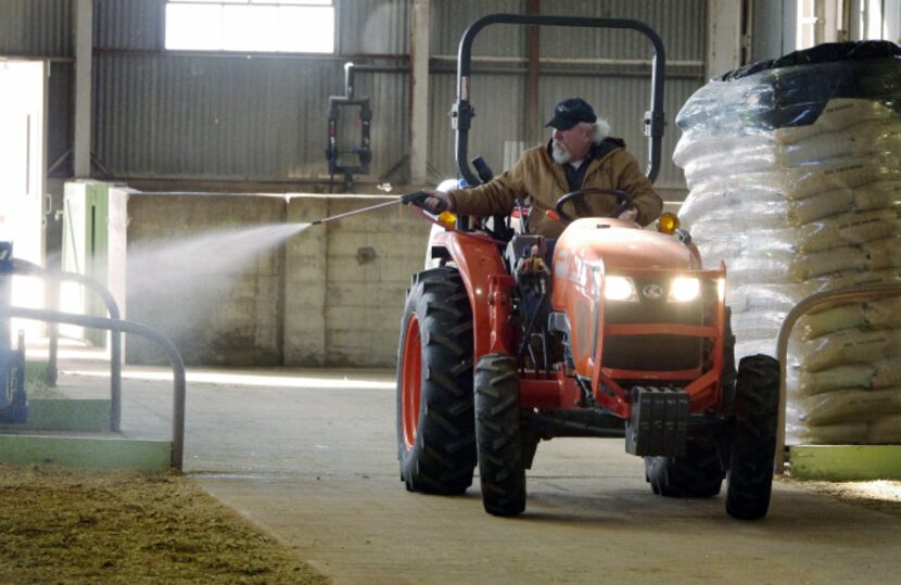 Kenneth Coe deodorizes Cattle Barn 3 for the Junior Heifer show. Staff must swiftly conduct...