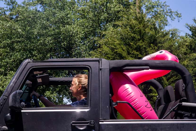 Karina Boyea (center) and her sister Marley (not pictured, passenger seat) drive to a pool...