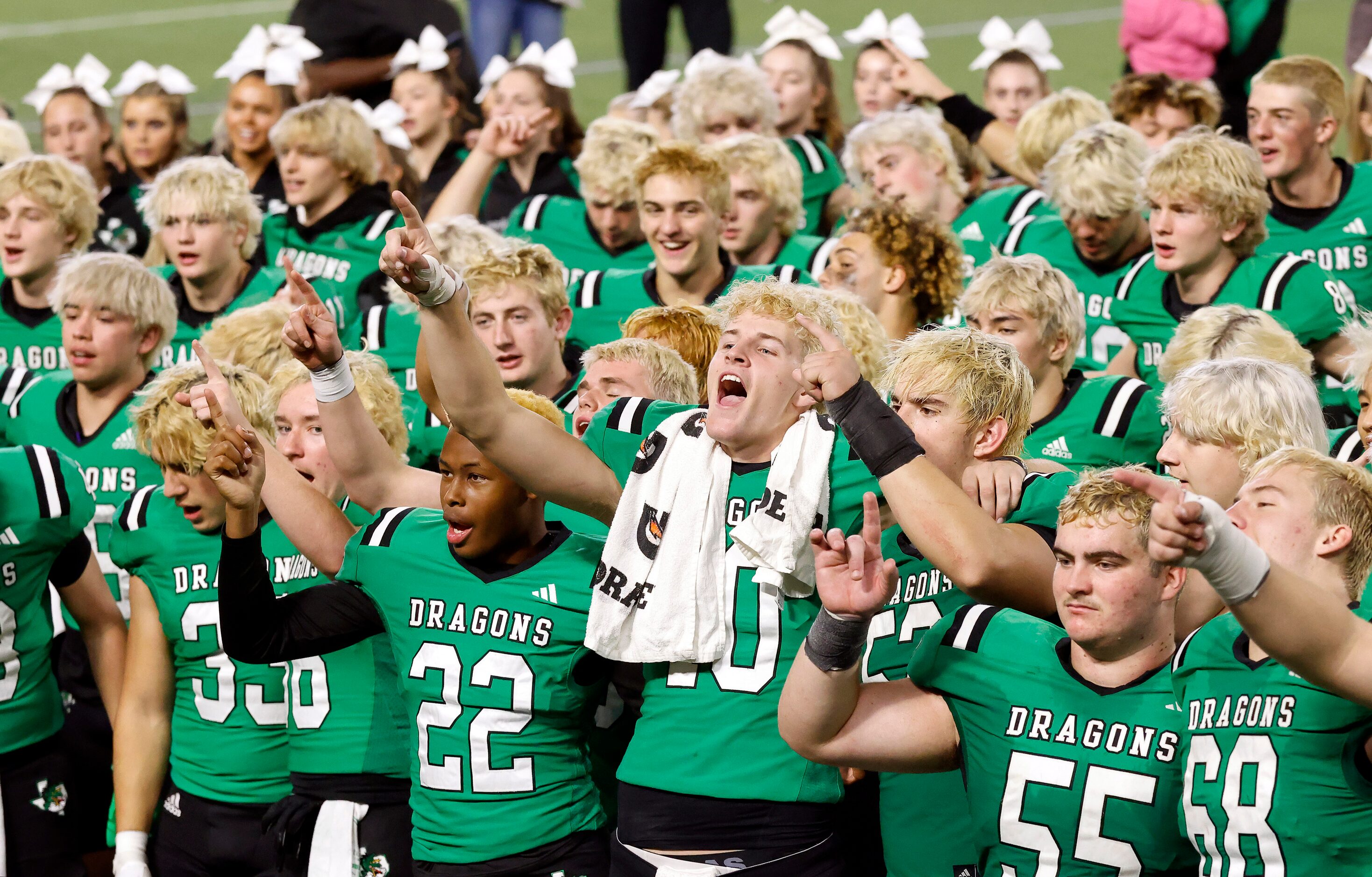 Southlake Carroll quarterback Graham Knowles (10, center) leads his teammates in the school...