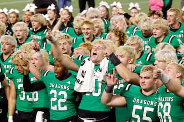 Southlake Carroll quarterback Graham Knowles (10, center) leads his teammates in the school...