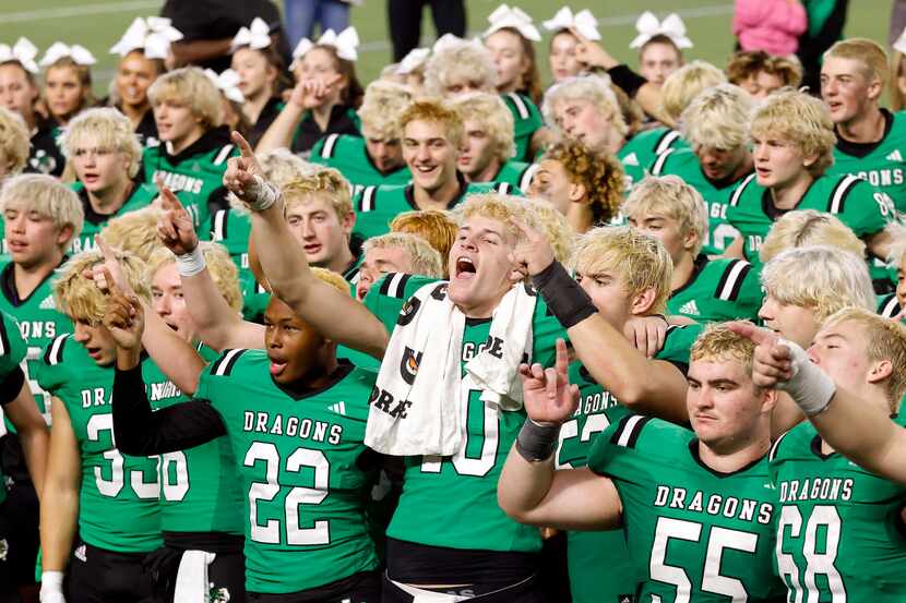 Southlake Carroll quarterback Graham Knowles (10, center) leads his teammates in the school...