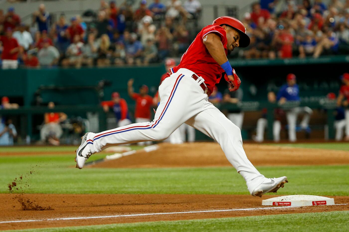 Texas Rangers designated hitter Andy Ibanez (77) reaches third base during the fourth inning...