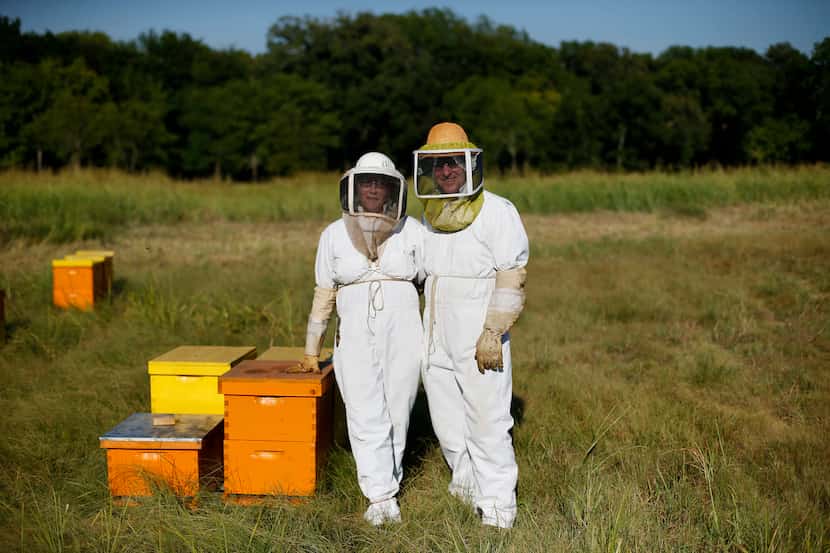 Beekeepers Lisa Dittfurth (left) and her husband, Russell Dittfurth, stand at Crooked Creek...