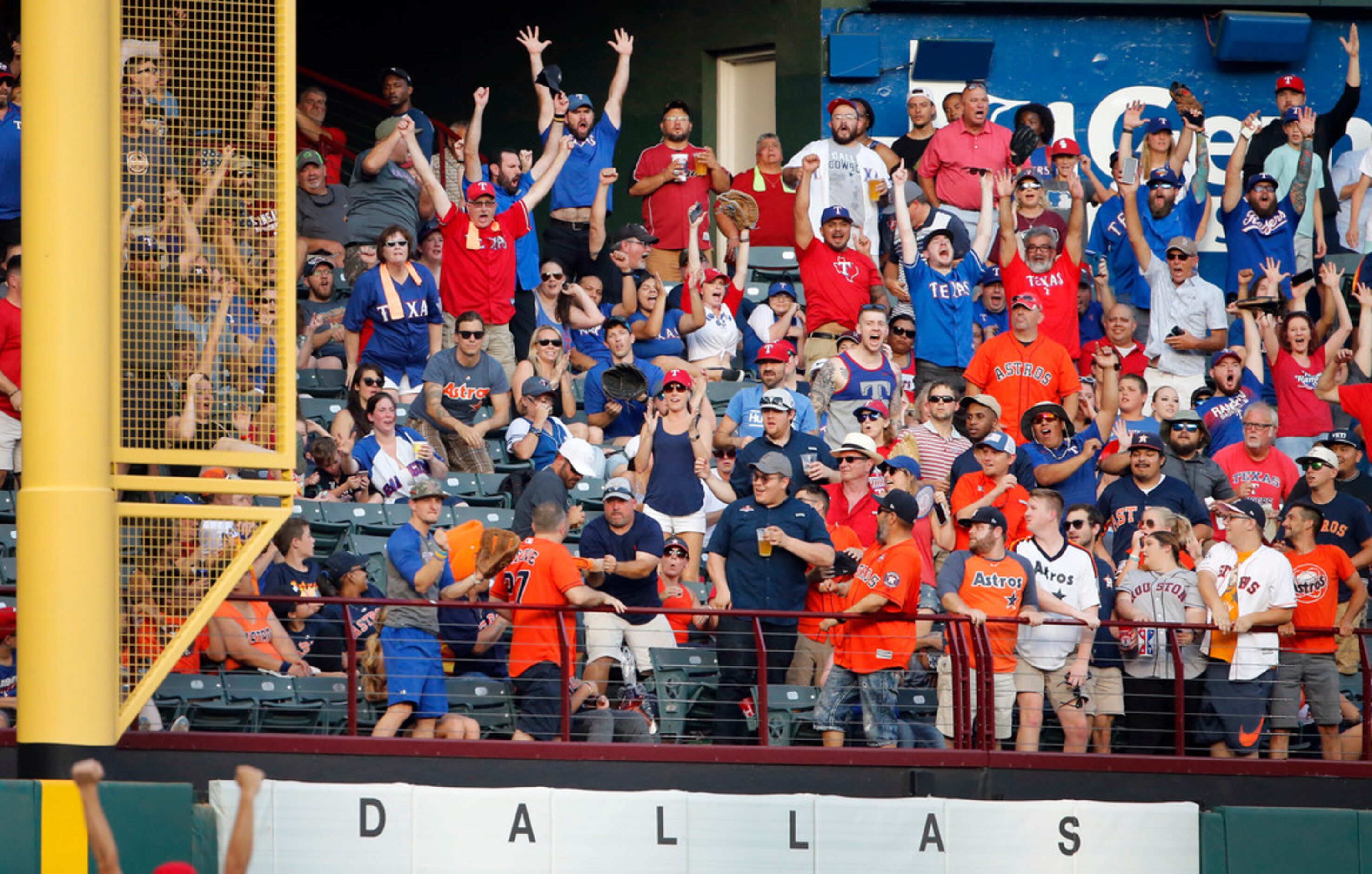 Texas Rangers fans cheers as batter Shin-Soo Choo's home run ball clears the left field wall...