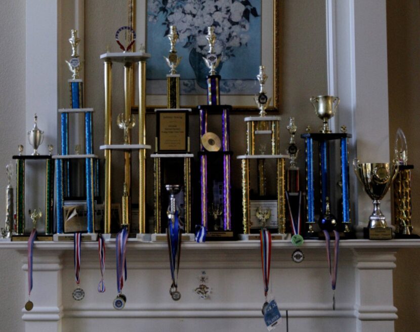 Jeffery’s chess trophies and medals adorn the fireplace mantel of the Xiong home in Coppell..