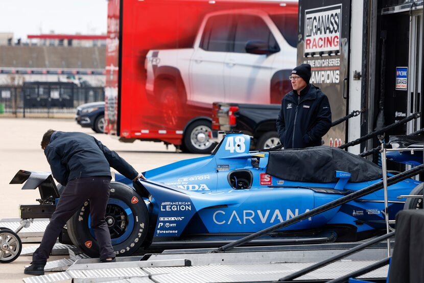 Chip Ganassi Racing crew members load the #48 car of Jimmie Johnson after a planned testing...