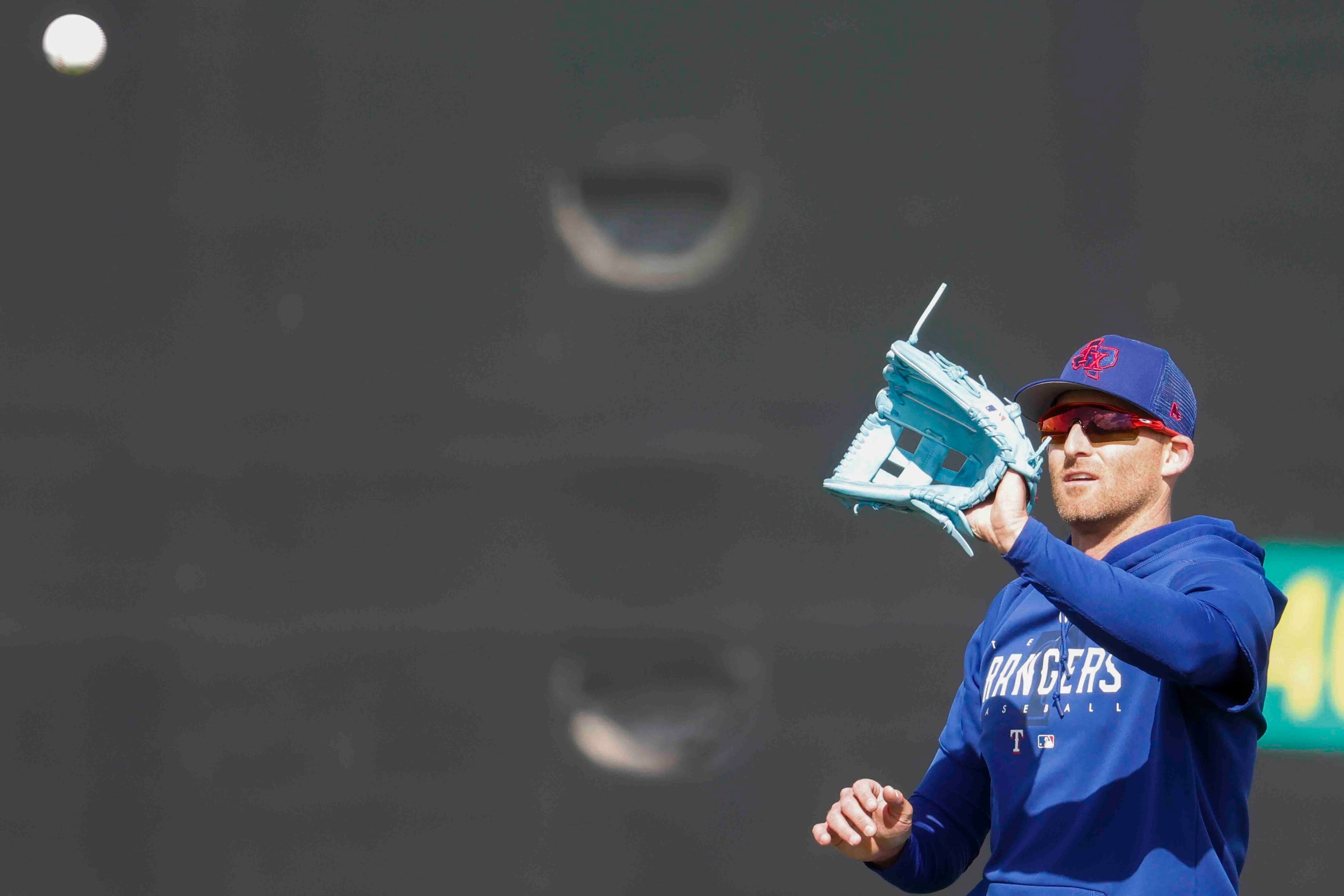 Texas Rangers outfielder Brad Miller catches a ball during a spring training workout at the...