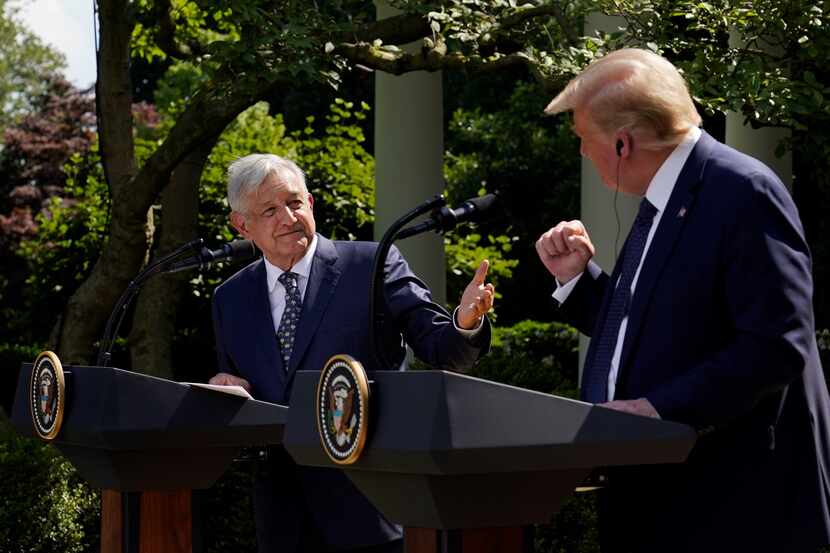President Donald Trump and Mexican President Andres Manuel Lopez Obrador gesture before...