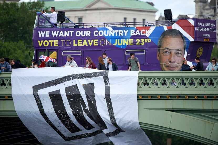 Campaigners to remain in the EU unfurl a banner on Westminster Bridge as a bus bearing the  ...