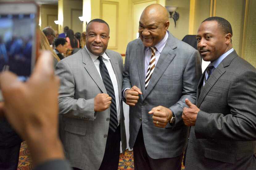 Texas Black Sports Hall of Fame inductee George Foreman, center, poses for a photo with...