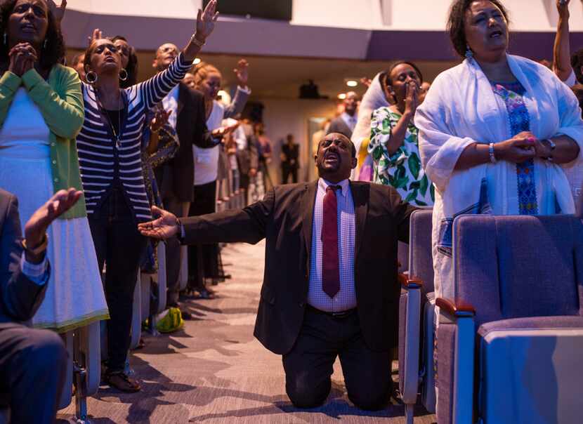 The congregation prays  at the Ethiopian Evangelical Baptist Church in Garland.