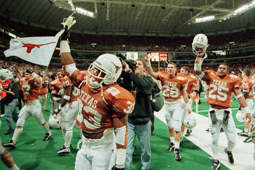 University of Texas running back Priest Holmes ( 33) and teammates (including Anton Hector...
