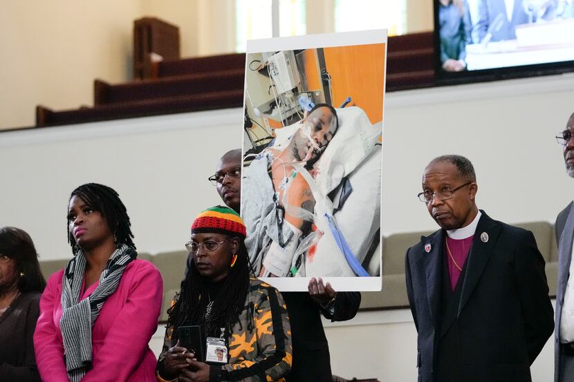 FILE - Family members and supporters hold a photograph of Tyre Nichols at a news conference...