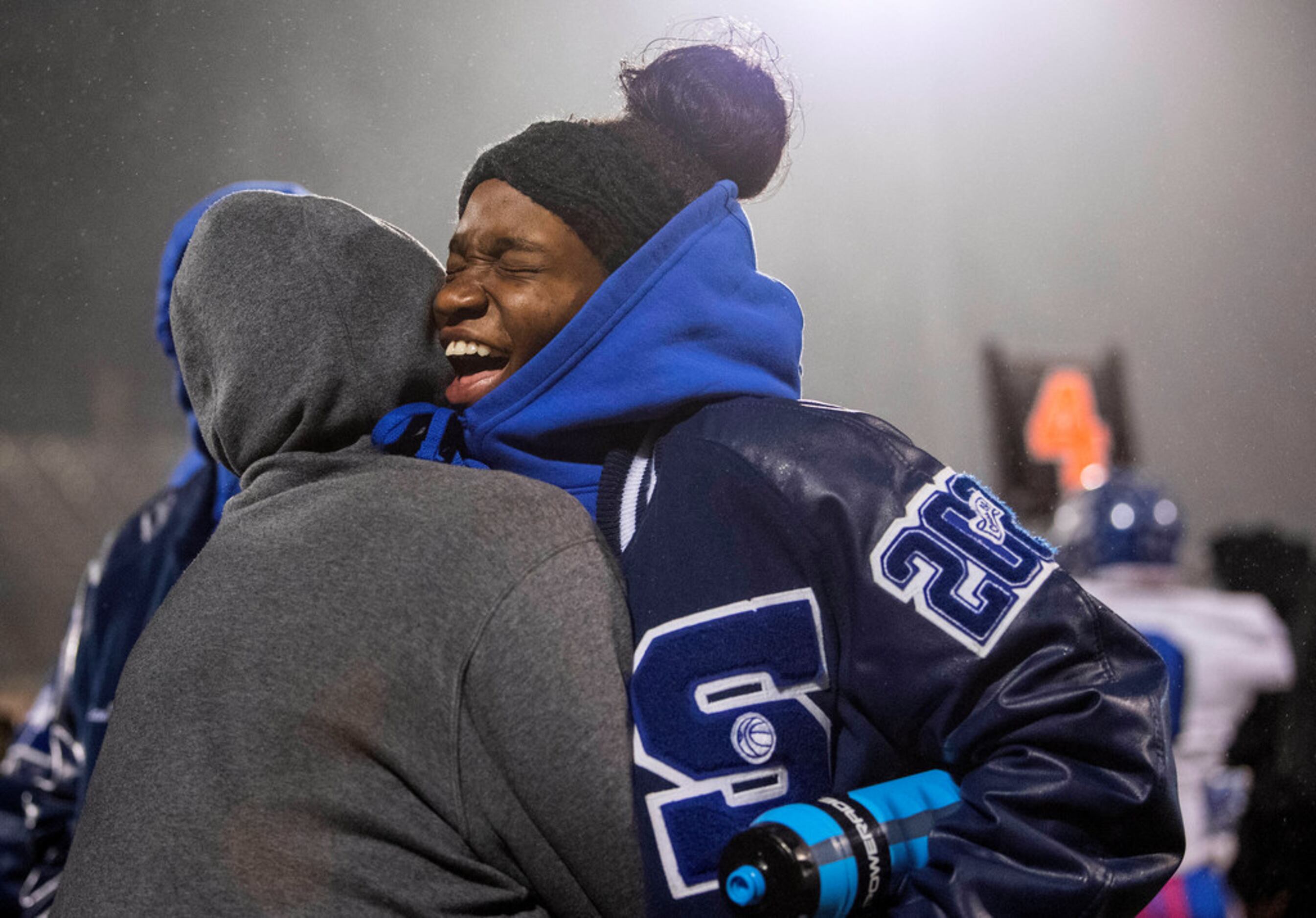 Seagoville athletic trainers Stephanie Watkins, right, and LaKaiya Garrett lean in close to...