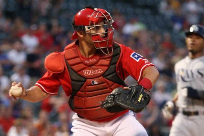 ORG XMIT: *S197DBBB7* Rangers catcher Ivan Rodriguez makes a double play in the first inning...