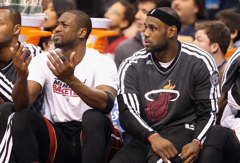 DALLAS, TX - DECEMBER 20:  (L-R) Dwyane Wade #3 and LeBron James #6 of the Miami Heat sit on...
