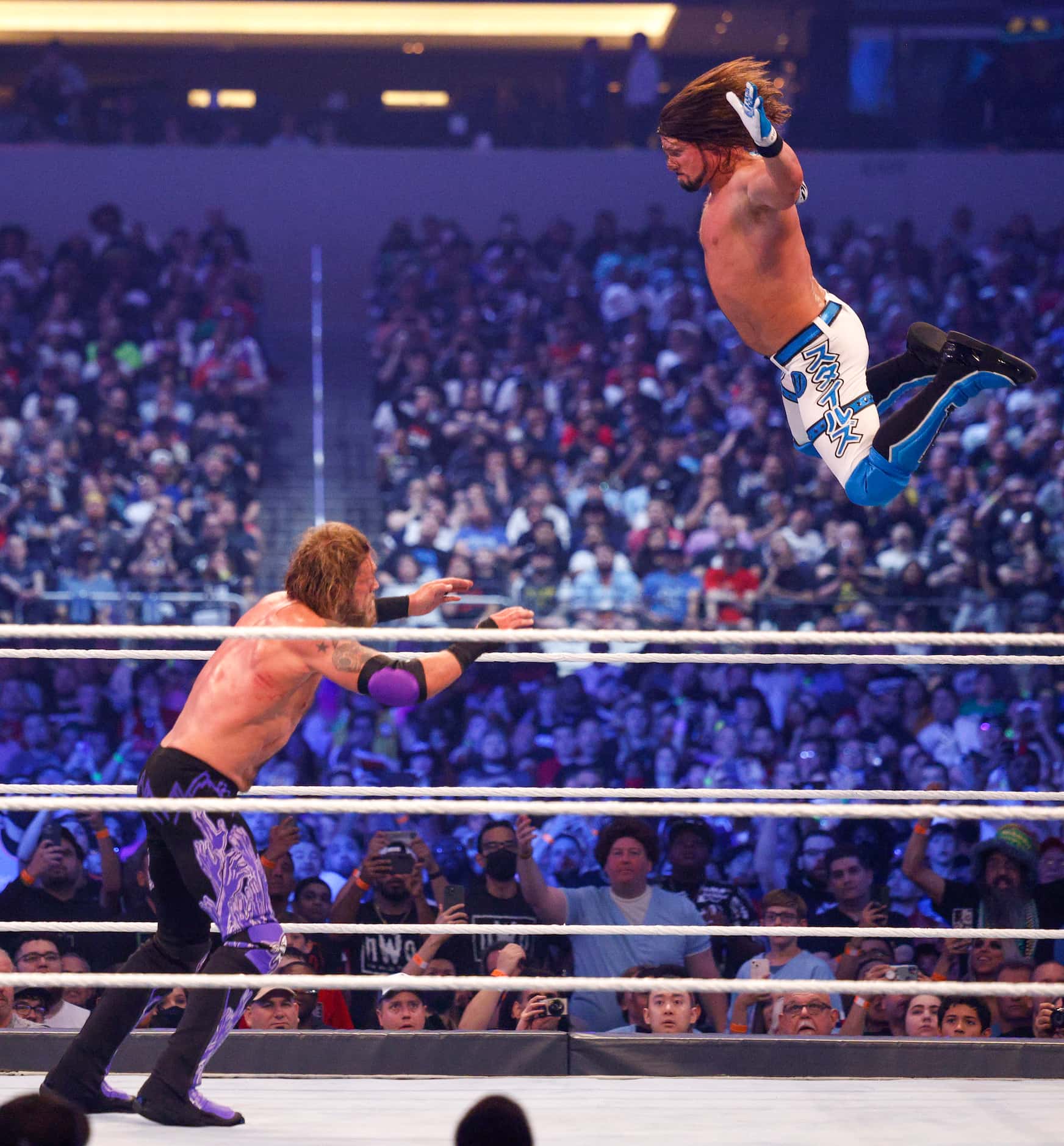 AJ Styles jumps from the ropes onto Edge during a match at WrestleMania Sunday at AT&T...