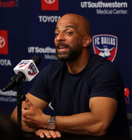 Peter Luccin, the new FC Dallas interim head coach converses with a media member during a...