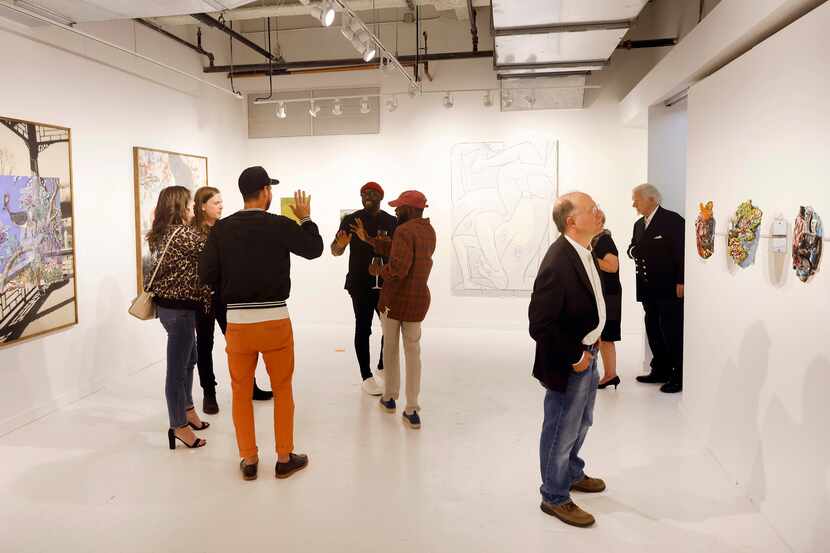 Patrons peruse the artwork at the 2022 edition of the Dallas Art Fair at Fashion Industry...