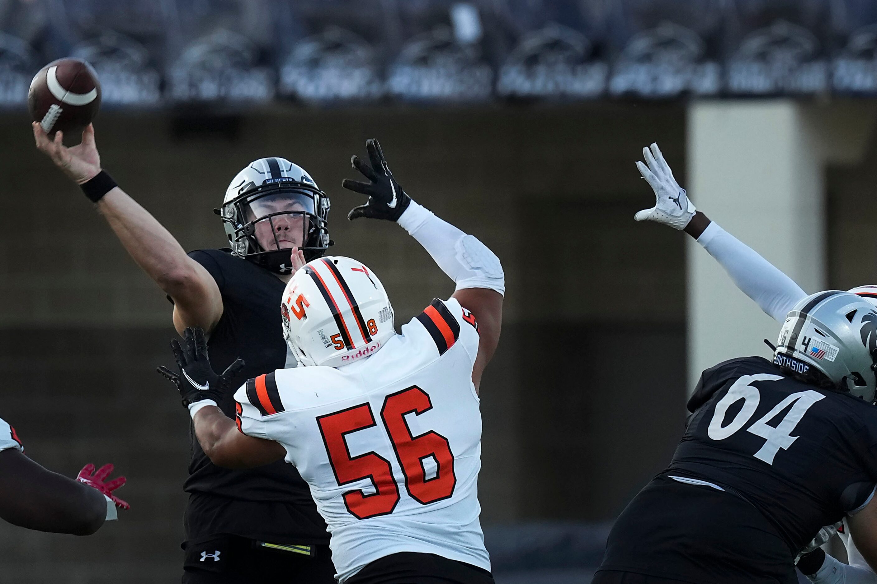 Denton Guyer quarterback Jackson Arnold (11) gets off a pass under pressure from Lancaster...