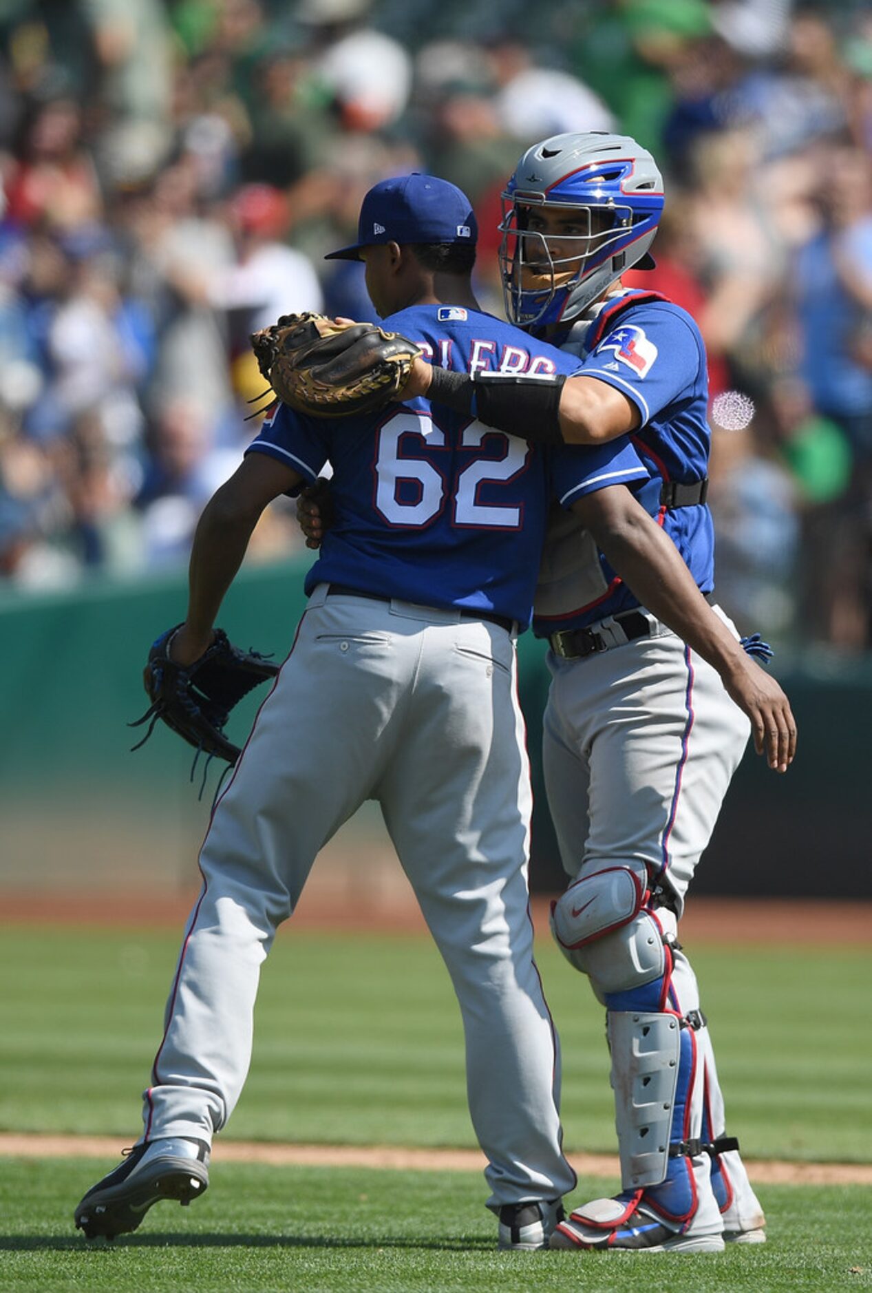 OAKLAND, CA - AUGUST 22:  Jose Leclerc #62 and Robinson Chirinos #61 of the Texas Rangers...