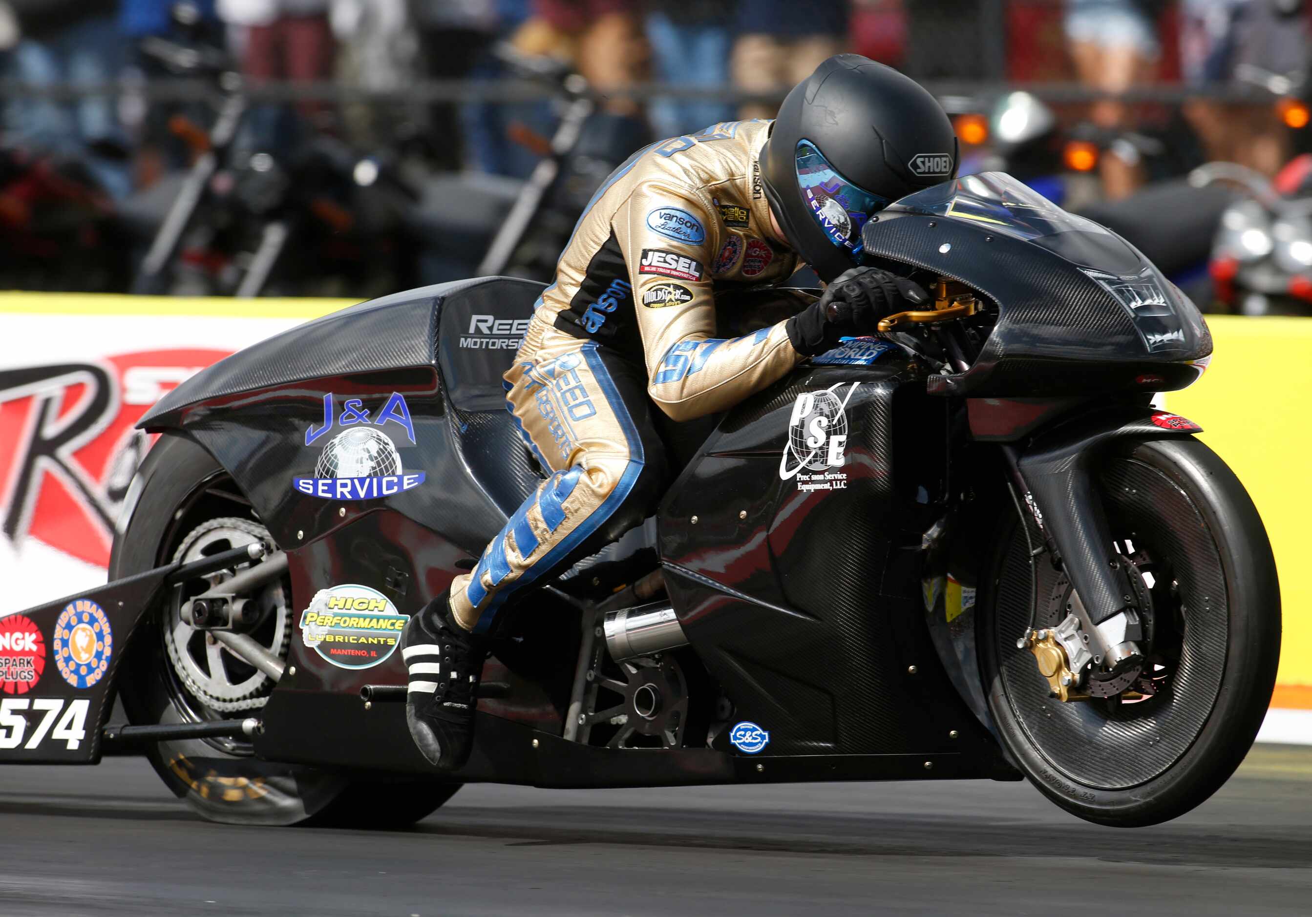 C. Reed lunges from the starting line for his preliminary race in the Pro Stock Motorcycle...